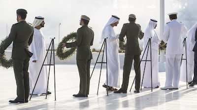 Sheikh Mohammed bin Zayed, Sheikh Mohammed bin Rashid and Sheikh Hamad bin Mohammed Al Sharqi, Ruler of Fujairah, place wreaths during a Commemoration Day ceremony at Wahat Al Karama. Ryan Carter / Crown Prince Court - Abu Dhabi