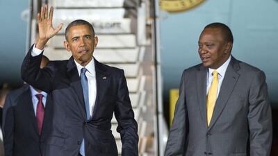 US president Barack Obama waves as he walks with Kenyan president Uhuru Kenyatta after arriving at Kenyatta International Airport on July 24, 2015. Evan Vucci/AP Photo