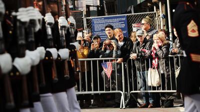 People watch as US Marines march in the Veterans Day Parade. AFP