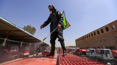 A Yemeni worker sprays disinfectant on a truck in the capital Sanaa. AFP