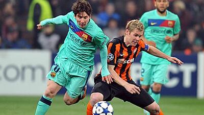 Barcelona's Lionel Messi, left, battles for the ball with Shakhtar's Tomas Hubschman during the second-leg of their Champions League quarter-final.