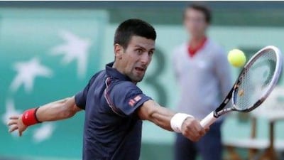 Serbia's Novak Djokovic returns the ball to Switzerland's Roger Federer.