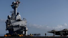 Military personnel and Rafale jet fighters on the deck of the French aircraft carrier Charles de Gaulle. AFP
