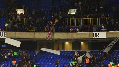 Arsenal fans remove signage at White Hart Lane on Wednesday night following a win over Tottenham Hotspur in the League Cup. Tom Dulat / Getty Images