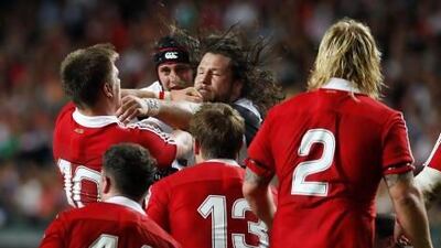 Barbarians’ Martin Castrogiovanni, centre, gets to grips with British & Irish Lions’ Owen Farrell, left, in Hong Kong yesterday.