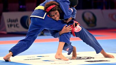 Fatima Rashid Al Falahi (yellow belt) shown in her match against Ariel Oliveira in female 50.5 kilograms semi-final yesterday at the Abu Dhabi Jiu-Jitsu Children's World Championship. Ravindranath K / The National