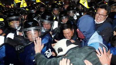 Protesters struggle with riot police as they try to march during a rally in central Seoul yesterday against the G20 Summit.