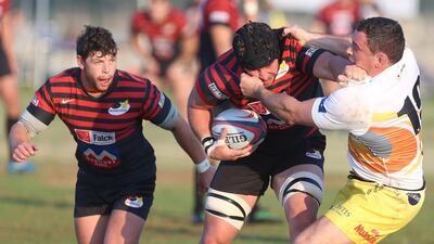 Jaen Botes, centre, breaks through a tackle while carrying the ball in a game against the Dubai Hurricanes on January 23, 2015, in Abu Dhabi. Delores Johnson / The National