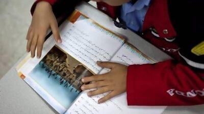 Students from the Al Ruwais Primary Boys School reading during an Arabic language class. Silvia Razgova / The National