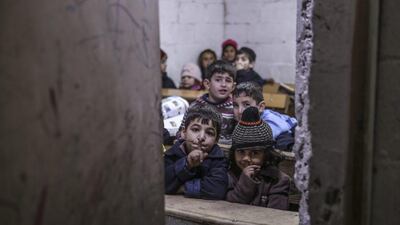 Syrian children gesture for silence in a classroom at school in the Al-Qaboun neighbourhood of Damascus, Syria. Mohammed Badra / EPA
