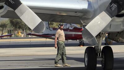 A ground crewman carries out a pre-flight check on a Royal Australian Air Force AP-3C Orion prior to its takes off at RAAF Pearce Base to join the search for the missing Malaysia Airlines flight MH370. Rob Griffith / AP