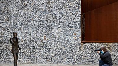 A photographer takes a shot of the life-sized statue. AFP