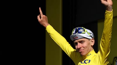 UAE Team Emirates' Slovenian rider Tadej Pogacar celebrates on the podium. AFP