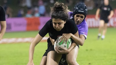An Al Arabi player is tackled during the match against Al Maha.