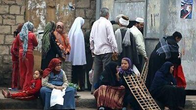 People queue for bread at Magra El-Oyoun market on January 24, 2012 in Cairo, Egypt. Jeff J Mitchell / Getty Images