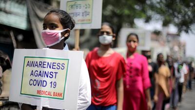 Volunteers take part in a Covid-19 awareness rally to mark World Health Day, in Kolkata, India, on April 7, 2021. EPA