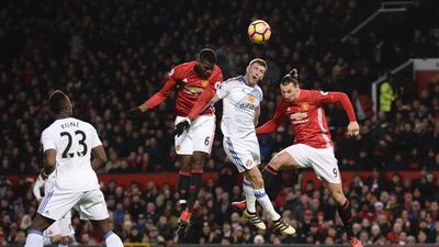Manchester United's Paul Pogba heads the ball against Sunderland's Billy Jones at Old Trafford on February 15, 2017, Oli Scarff / AFP