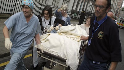 Medical staff stretcher a victim away from Russell Square station. The most deadly attack occurred on the Piccadilly line between King's Cross and Russell Square, killing 26 people