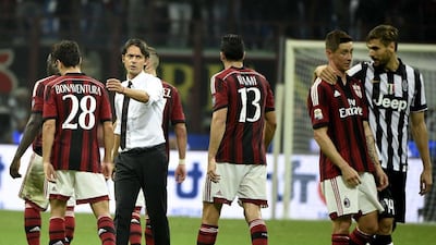 AC Milan's coach Filippo Inzaghi, second left, acknowledges his players after their Serie A match against Juventus on Saturday. Olivier Morin / AFP / September 20, 2014