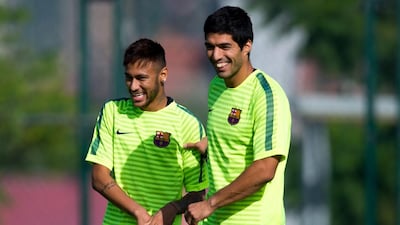 Neymar, left, and Luis Suarez of Barcelona share a joke during a training session ahead of their Uefa Champions League Group F match against Ajax at Ciutat Esportiva on October 20, 2014, in Barcelona, Spain. David Ramos / Getty Images