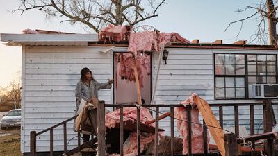 Altharis Threatt stands on the porch of her daughter-in-law's tornado-ravaged trailer home in Mount Vernon, Alabama. EPA