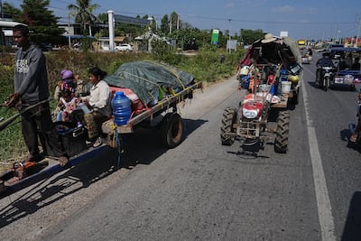 People leave a border area of Cambodia as fighting escalates. AP
