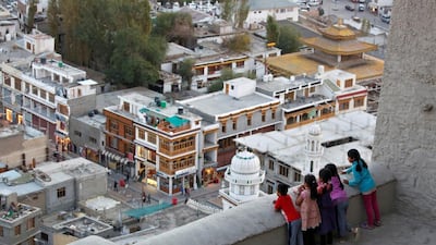 Children look down from the Royal Palace in Leh.