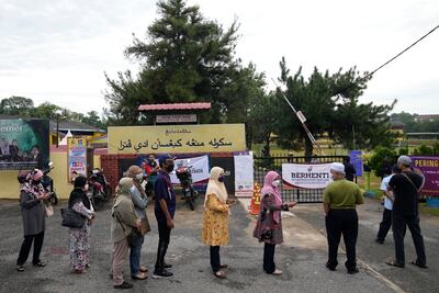 Voters line up on the outskirts of Melaka, Malaysia, on Saturday to vote during the state election. AP Photo