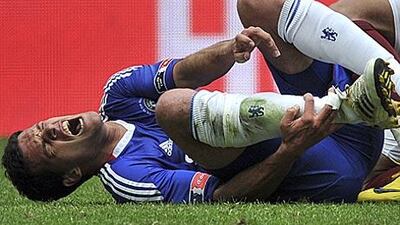 Michael Ballack holds his ankle after the challenge by Portsmouth's Kevin-Price Boateng during the FA Cup final.