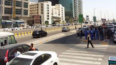 Abu Dhabi Police cars have cordoned off the area surrounding the building, including the adjacent bridge leading to Al Maryah Island. Debris can be seen falling off the side of the building. Photo courtesy Shanavas Pulickal
