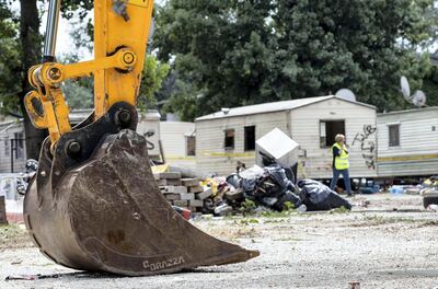 Mandatory Credit: Photo by MASSIMO PERCOSSI/EPA-EFE/Shutterstock (9771930a) A general view shows the mechanic shovel of an excavator machine during the removal of the last housing modules at the 'Camping River' Roma camp in Rome, Italy, 27 July 2018. Rome Mayor Virginia Raggi on 26 July hailed the clearance and closure of the Camping River Roma camp in the Italian capital. The European Court of Human Rights (ECHR) had called for the clearance of the site to be suspended after an appeal by three inhabitants. The Rome city council informed the court about the issue and said that the clearance was necessary due to public health risks. Clearing of gypsy camp in Rome, Italy - 27 Jul 2018