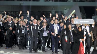 Matthew Hawkins, wearing a blue suit and tie, smiles alongside New Zealand's Special Olympic athletes at the opening ceremony on Thursday. Mohamed Al Baloushi.