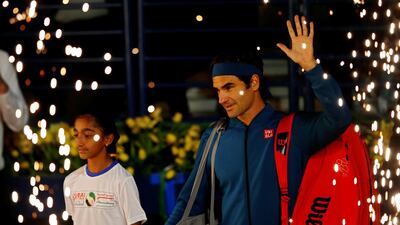 Federer and Tsitsipas arrive on court before the game starts. EPA