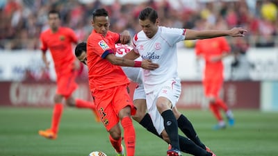 Barcelona's Neymar, left, competes for the ball with Grzegorz Krychowiak of Sevilla during their Primera Liga match at Estadio Ramon Sanchez Pizjuan on April 11, 2015, in Seville, Spain. Gonzalo Arroyo Moreno / Getty Images