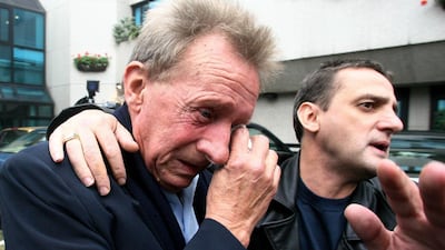 Denis Law, accompanied by George Best's manager Phil Hughes, leaves London's Cromwell Hospital in 2005. PA