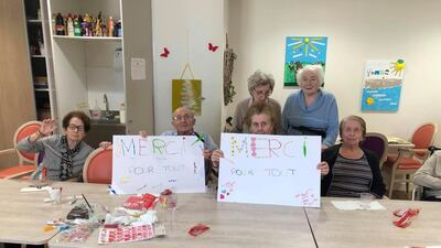 In this photo provided by the Vilanova nursing home, residents show posters reading "Thank you for everything" on April 27 2020 AP