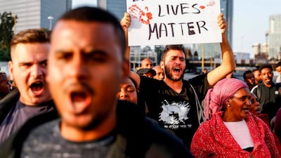 Israelis of Ethiopian origin chant slogans as they stand along a highway they are blocking during a protest against police violence in the coastal city of Tel Aviv on January 30, 2019. AFP