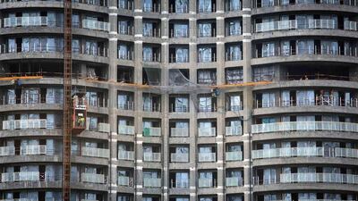 Labourers work at a construction site of a high-rise residential building in central Mumbai. Danish Siddiqui / Reuters