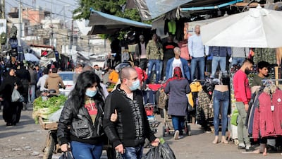Lebanese, some wearing protective masks due to the COVID-19 pandemic, shop at a market in the Sabra neighbourhood of Beirut. The Lebanese government announced tightened restrictions through January in a bid to contain a spike in novel coronavirus infections threatening to overwhelm its health infrastructure. The authorities had eased measures in December but scenes of revellers thronging bars and clubs during the holiday season had left little doubt that fresh restrictions were on the way. AFP