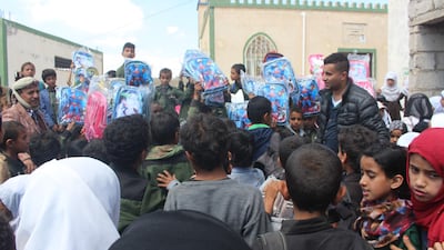 After raising funds for 200 bags, Ali Alsonidar distributes new back-packs to children in need. Ali Alsonidar