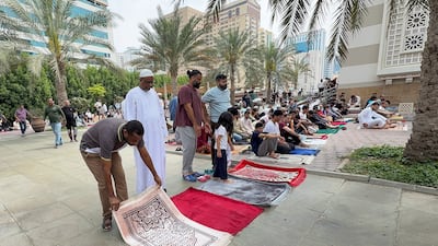 Worshippers gather for Friday prayers at Al Qasba mosque in Sharjah. Ahmed Ramzan / The National