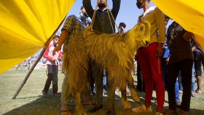 Kashmiris purchase goat at a livestock market ahead of Eid Al Adha in Srinagar, the main city in Indian-controlled Kashmir. AP Photo