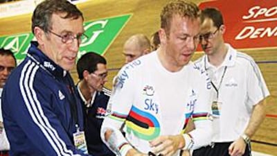 Sir Chris Hoy, right, gets medical aid after he crashed during a World Cup meeting in Copenhagen at the weekend.