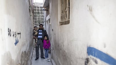Hamidi with his daughter Aya (7) and youngest son Mohamad (4), outside their shelter. Hamidi (34), his wife Noufa (37) and their six children fled their home in the countryside near Aleppo, Syria in 2013, fearing for their lives. Sebastian Rich / UNHCR/