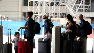 Travellers wait for transport outside of the Los Angeles International Airport. AP