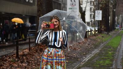 A guest poses in the street on February 28, 2016, before the Dolce Gabbana segment of the Women Autumn / Winter 2016 Milan Fashion Week. Gabriel Bouys / Agence France-Presse