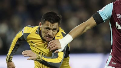 Arsenal's Alexis Sanchez chases as he is held by West Ham's Winston Reid at The London Stadium in London on Saturday December 3, 2016. Tim Ireland / AP