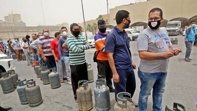 People queue o refill their gas cylinders in Kuwait City on May 10, 2020 as a 20-day coronavirus lockdown went into effect. AFP