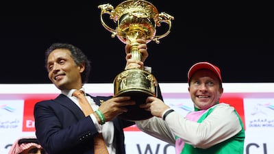 Trainer Bhupat Seemar and Tadhg O'Shea celebrate with the trophy after winning the Dubai World Cup. Reuters