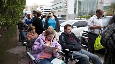 People wait in line in the early hours to be the first to buy tickets to the Dubai Duty Free Tennis Championships at the Dubai Tennis Stadium in Garhoud. Razan Alzayani / The National